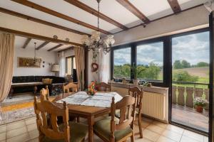 a dining room with a table and a couch at Ferienwohnung Waidbachhof in Sinsheim