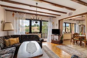 a living room with a couch and a television at Ferienwohnung Waidbachhof in Sinsheim