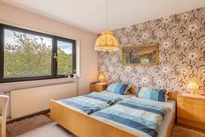 a bedroom with a bed and a window at Ferienwohnung Waidbachhof in Sinsheim