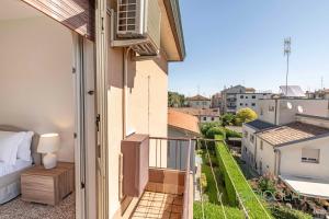 a balcony with a bed and a view of a city at Mestre Homey Apartment by Bricola Apartments in Venice