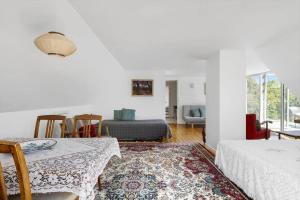 a living room with a table and chairs and a couch at 6763-Allinge-Sdr-Strandvej-69 in Allinge