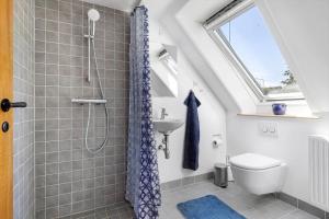 a bathroom with a shower with a toilet and a sink at 6763-Allinge-Sdr-Strandvej-69 in Allinge +14 photos