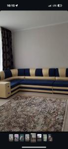 a couch sitting in a room with a rug at КАТОН КАРАГАЙ Пантолечебница in Altay +1 photo