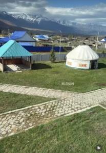 a yurt in a field with mountains in the background at КАТОН КАРАГАЙ Пантолечебница in Altay