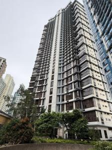 a large apartment building in a city at Executive Suites Bellagio Golf View Residences in Manila +11 photos