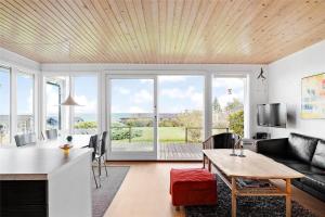 a kitchen and living room with a table and a couch at 6787-Allinge-Fjeldvej-8 in Allinge
