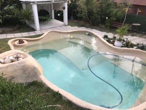 a large swimming pool with a hose in a yard at Table View Lodge in Cape Town