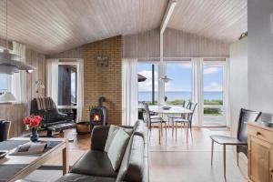 a living room with a couch and a table at 6683-Allinge-Brunekulvej-2-D in Allinge +12 photos