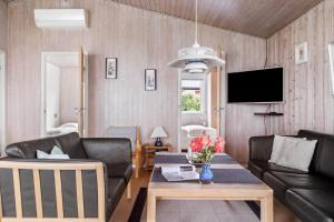 a living room with a couch and a table at 6683-Allinge-Brunekulvej-2-D in Allinge