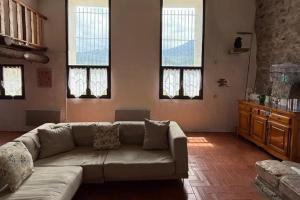 a living room with a couch and some windows at Wood Lodge - Sleeps10 - Skiing - Thermal Baths in Los Masos