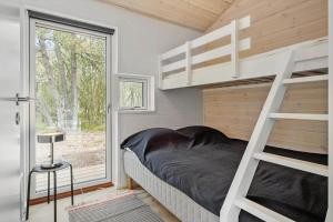 a bedroom with a bunk bed and a window at OH522-Hadsund-Vidjeparken-18 in Hadsund
