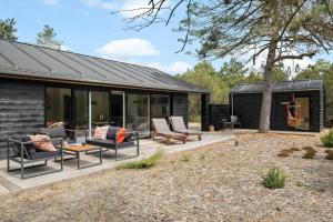 a patio with couches and a fireplace in a house at OH522-Hadsund-Vidjeparken-18 in Hadsund
