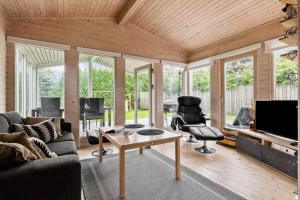 a living room with a couch and a table at OH526-Hadsund-Ved-Fruerlund-32 in Hadsund