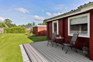 a deck with chairs and a table on a house at OH526-Hadsund-Ved-Fruerlund-32 in Hadsund