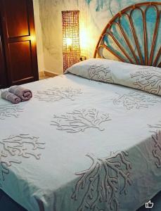 a bed with a blue and white comforter on it at Suite Maya in Posada