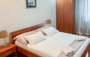 a bedroom with a bed with two towels on it at Amazing Apartment In Supetar in Supetar +8 photos