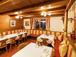 a restaurant with tables and chairs in a room at Pension Walserheim in Lech am Arlberg