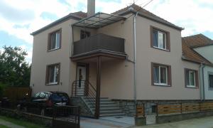 a house with a balcony on the side of it at Apartmány Vilma in Lednice