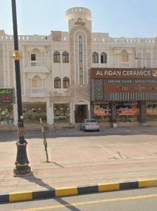 a street light in front of a large building at Blue Gold Rooms and Apartments in Firq
