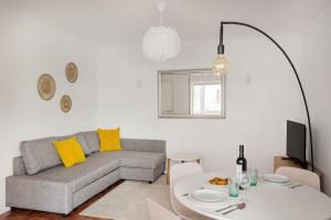 a living room with a couch and a table at Estoril Beach - Your Family Escape in Estoril