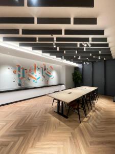 a conference room with a table and chairs in it at TranquiLoft LuxLiving in Cilenggang +129 photos