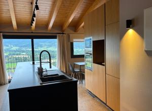 a kitchen with a sink and a counter top at CIM HOTEL BOUTIQUE in Puigcerdà