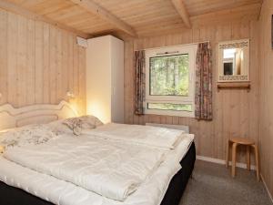 a bedroom with a large bed and a window at 6 person holiday home in Saltum in Saltum