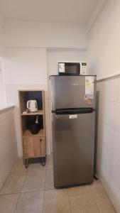 a kitchen with a refrigerator and a microwave on top of it at Beautiful 2 bedroom on the Cañitas Palermo border in Buenos Aires