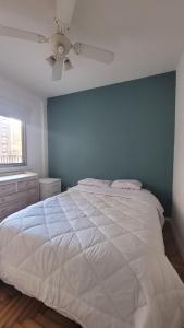 a bedroom with a white bed and a ceiling fan at Beautiful 2 bedroom on the Cañitas Palermo border in Buenos Aires
