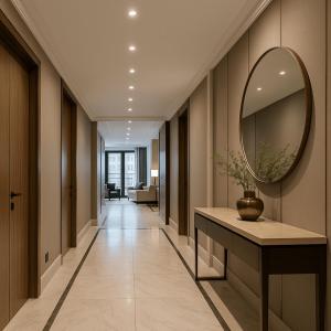 a hallway with a mirror and a table with a vase at Enad Place in Amman
