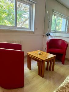 a living room with a coffee table and two chairs at Le Phoenica - Former Hotel - Parking in Carquefou