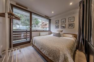 En eller flere senge i et værelse på Charmant duplex 2 chambres Courchevel 1550
