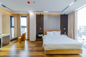 a hotel room with a bed and large windows at Emerald Dhaka Luxury Hotel in Dhaka