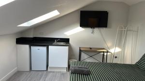 a room with a kitchen with a sink and a counter at Bright Studio on Brigstock Rd in Thornton Heath