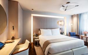 a hotel room with a bed and a desk at Mandarin Oriental Lutetia, Paris in Paris