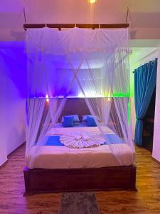 a bedroom with a bed with a canopy at Crest Cold Homestay in Ella