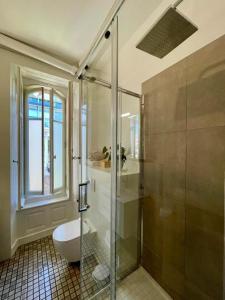 a bathroom with a glass shower and a toilet at Bellavista in Neuchâtel +83 photos