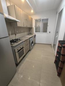 a kitchen with a stove and a dishwasher at S1 lux jardin carthage in Tunis