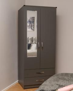 a bedroom with a gray cabinet with two pictures on it at Lovely 2 Bedroom Home Coventry in Tollbar End