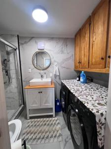 a bathroom with a washing machine and a sink at Beautiful Newly Renovated House in Roberval +14 photos