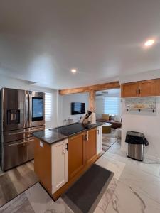 a large kitchen with a stainless steel refrigerator at Beautiful Newly Renovated House in Roberval