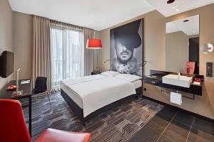 a hotel room with a bed and a sink at LÉGÈRE HOTEL Tuttlingen in Tuttlingen