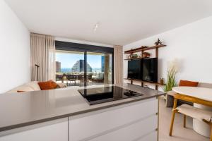a kitchen with a large counter top in a living room at Saeta 13B Calpe in Calpe