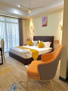 a bedroom with a large bed with yellow pillows at KIJICHI GATEWAY Hotel in Dar es Salaam +108 photos