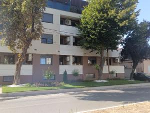 an apartment building with trees in front of it at Zemun residence in Novi Grad