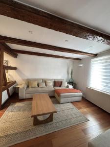 a living room with a couch and a table at Maison familiale alsacienne au centre ville in Obernai