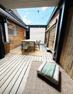 a patio with a table and chairs on a wooden deck at Maison familiale alsacienne au centre ville in Obernai