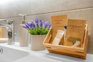 a basket of items sitting on a bathroom sink at Aura Suite near Lake Garda in Castiglione delle Stiviere