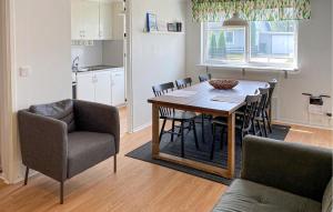 a kitchen and dining room with a table and chairs at Amazing Apartment In Pauliström With Wifi in Pauliström