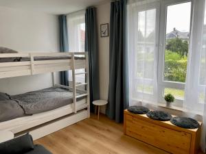 a bedroom with a bunk bed and a window at Möwennest in Nienhagen